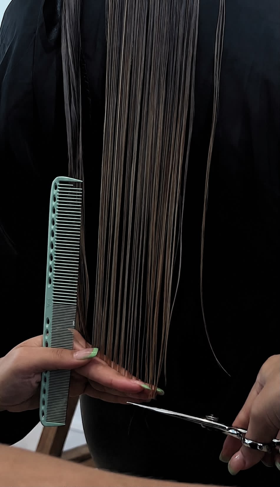 Stylist finishing a precision haircut
